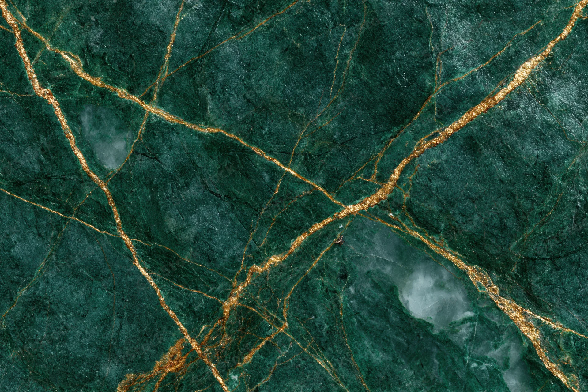 Close-up of deep emerald green marble slab with gold veining