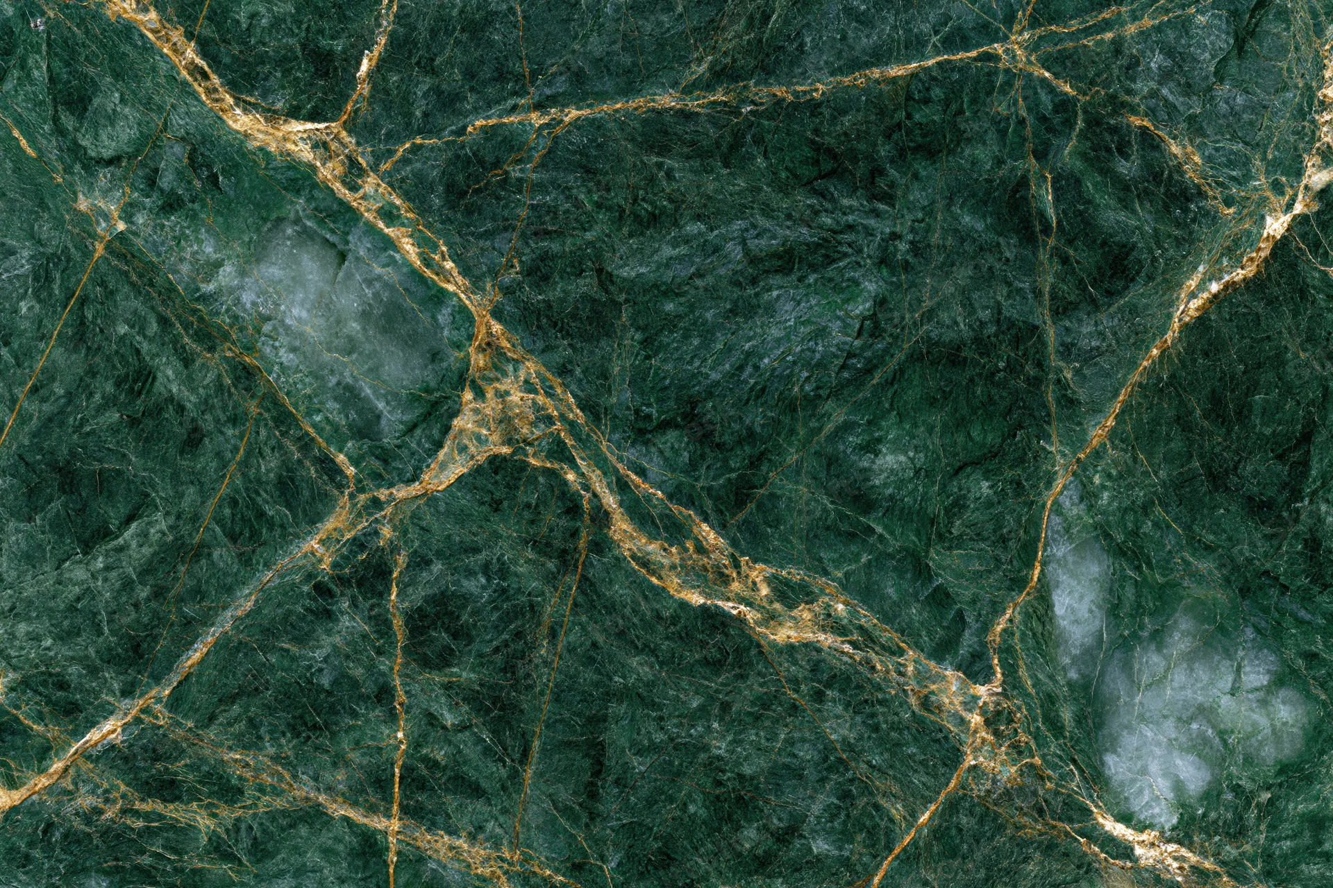 Close-up of deep emerald green marble slab with gold veining