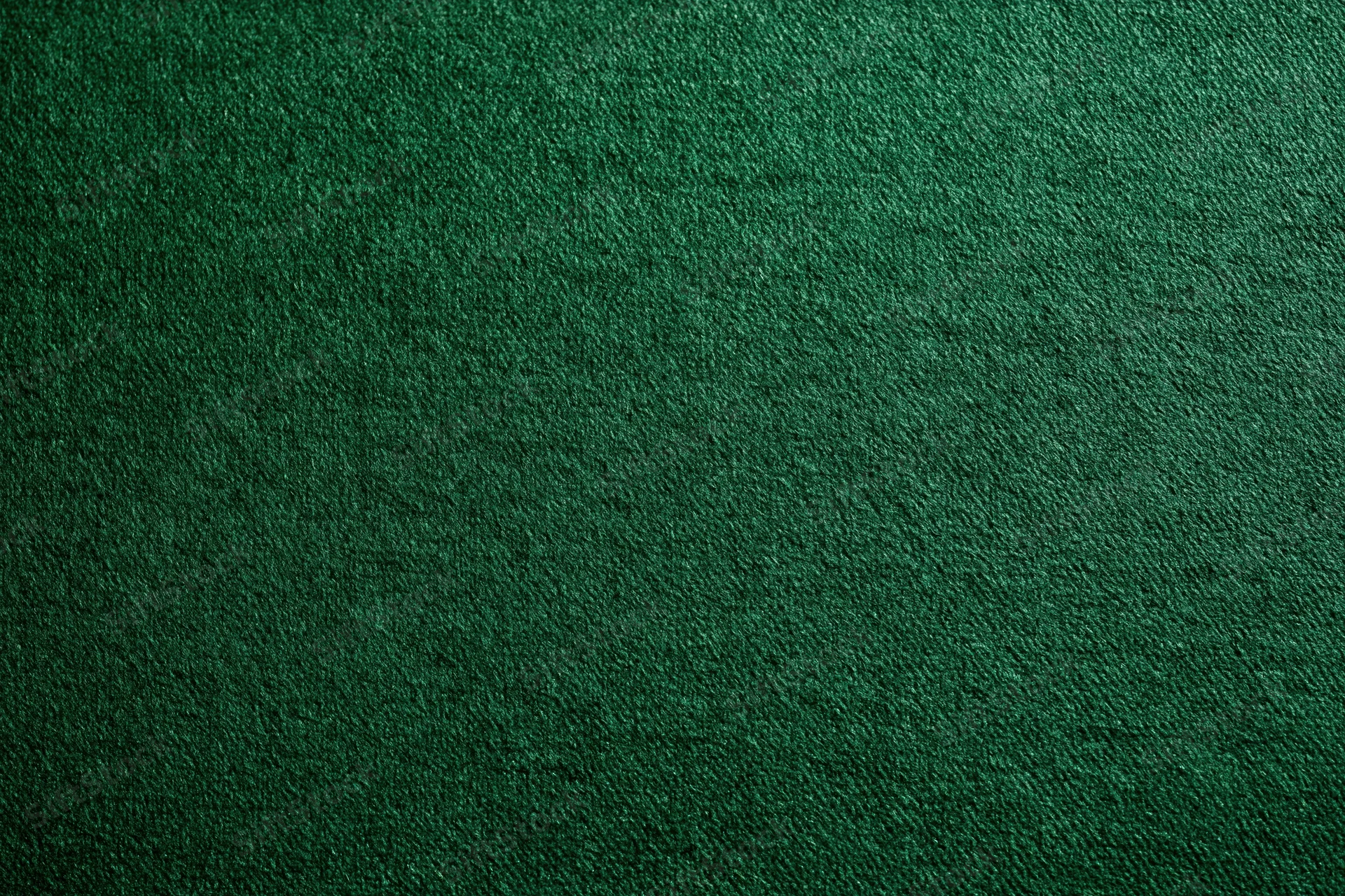 Close-up of deep green textured fabric surface