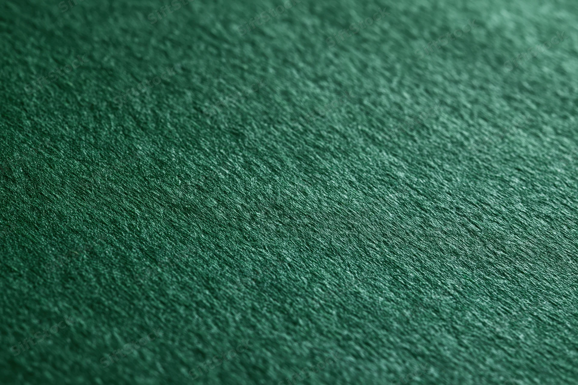 Close-up of deep green textured fabric surface