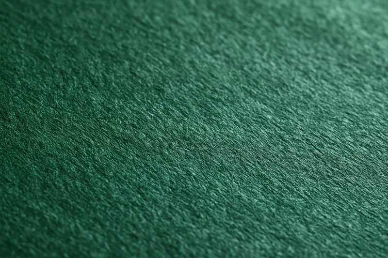Close-up of deep green textured fabric surface