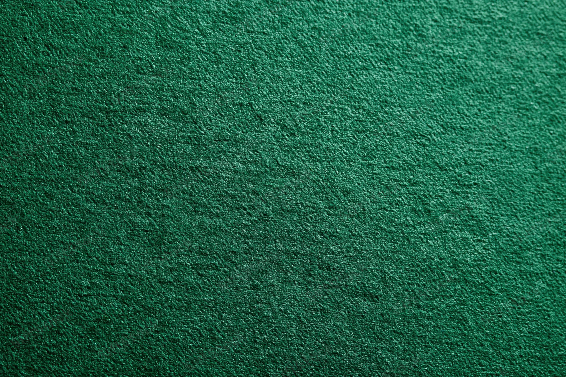 Close-up of deep green textured fabric surface