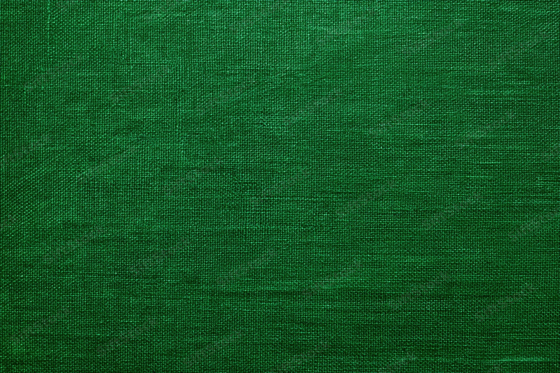 Close-up of deep green textured fabric surface in flat lay arrangement