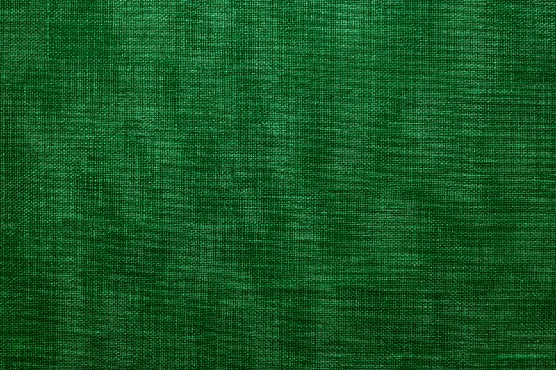 Close-up of deep green textured fabric surface in flat lay arrangement