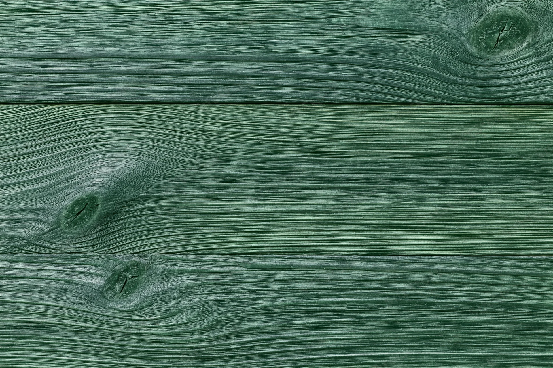 Close-up of green-stained wooden planks showing natural grain and texture