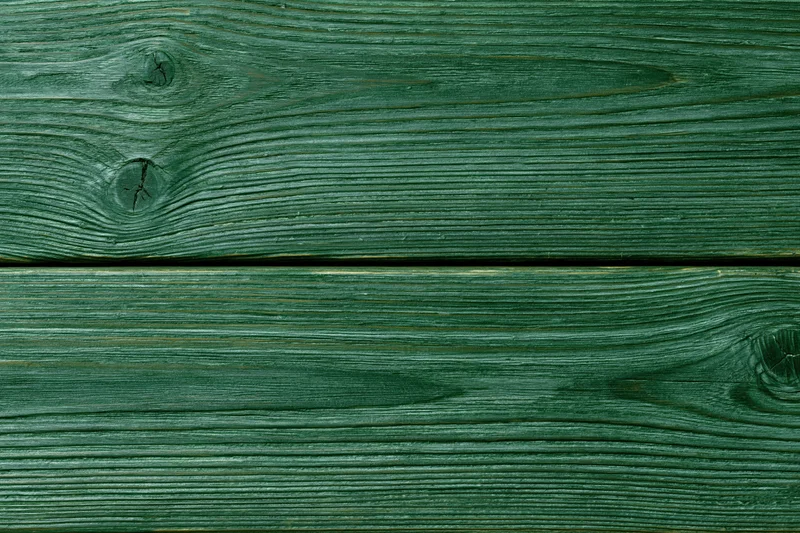 Close-up of green-stained wood planks showing natural grain and knots in horizontal arrangement