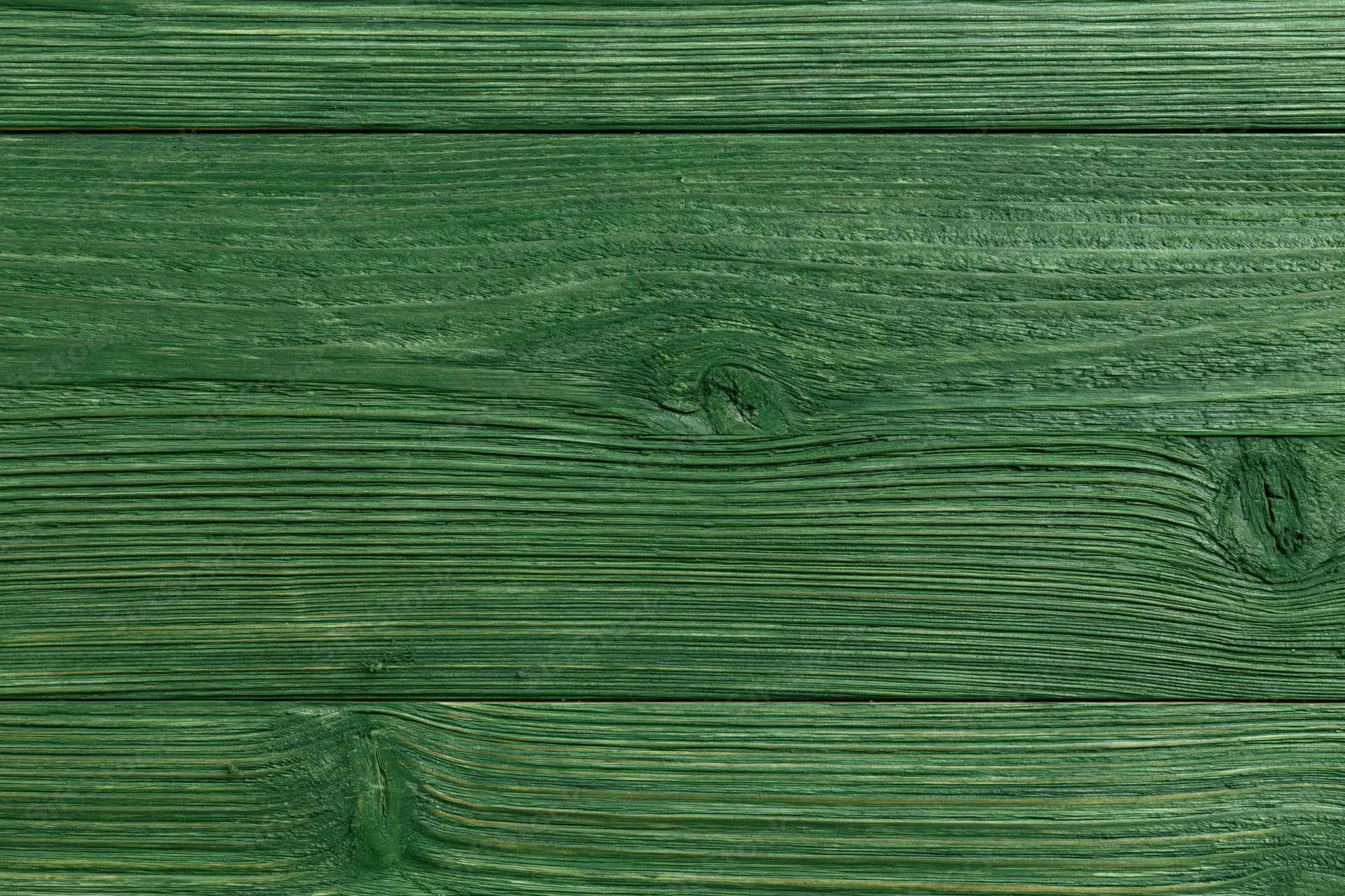 Green-stained wood planks arranged horizontally showing natural grain and texture