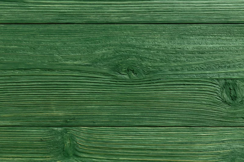 Green-stained wood planks arranged horizontally showing natural grain and texture