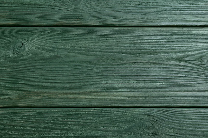 Close-up of green-stained wooden planks arranged horizontally as a textured surface