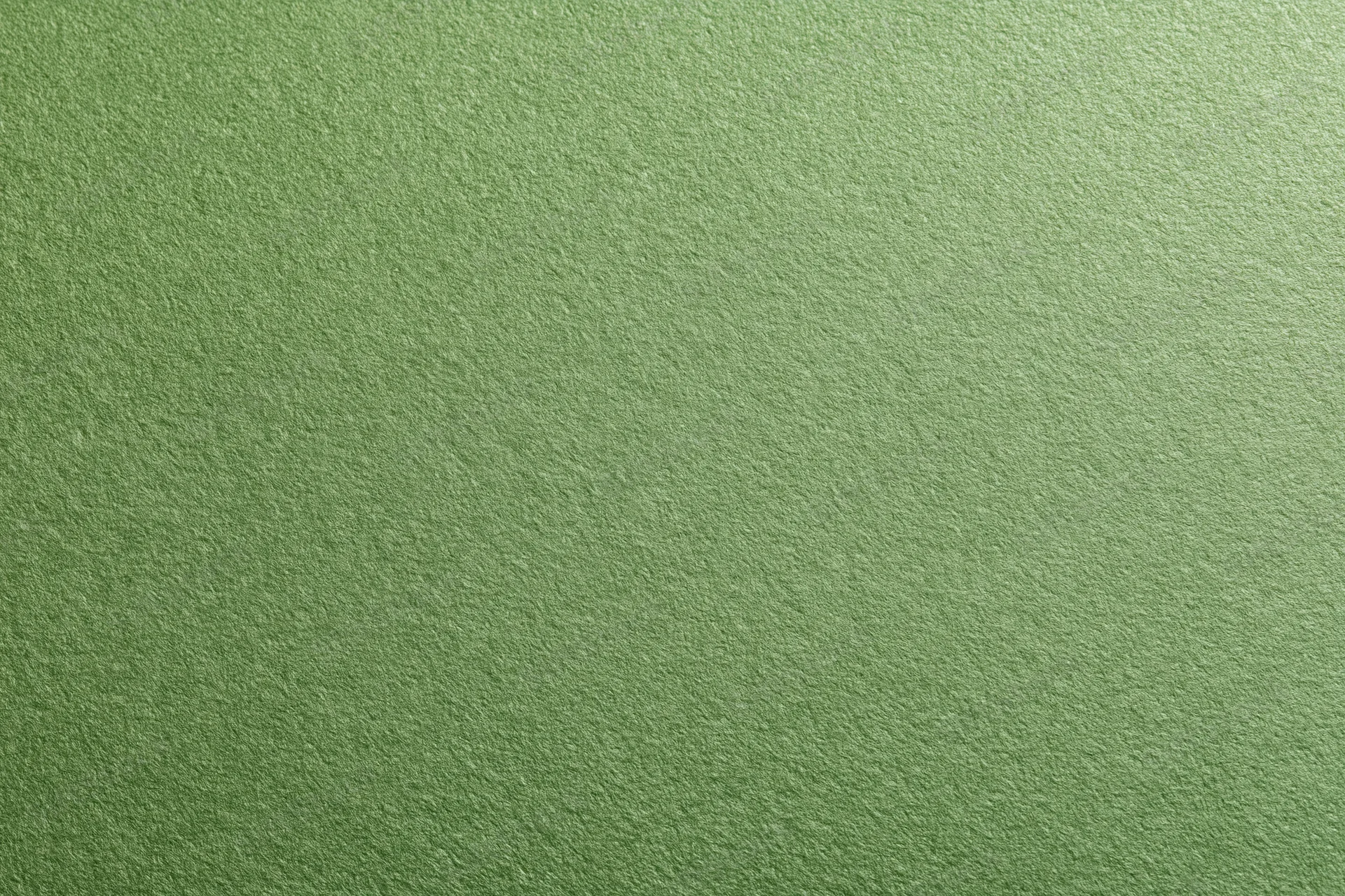 Close-up of muted olive green cardstock surface with visible texture and grain