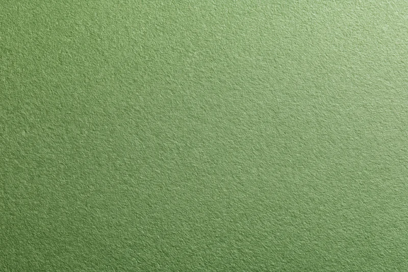 Close-up of muted olive green cardstock surface with visible texture and grain