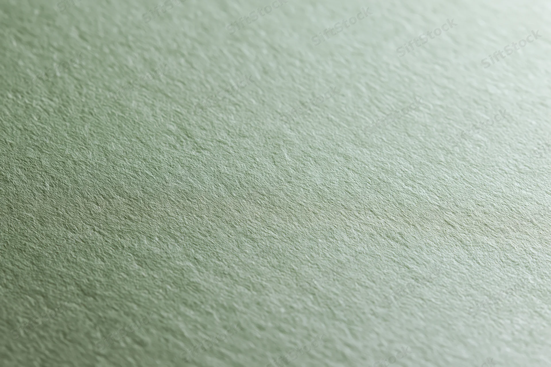 Close-up of sage green cardstock paper surface with textured finish