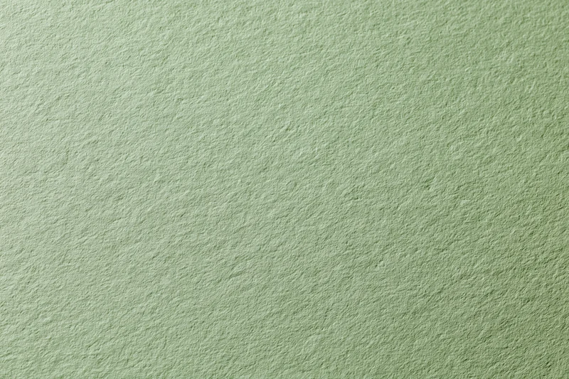 Close-up of sage green cardstock paper surface showing texture and grain
