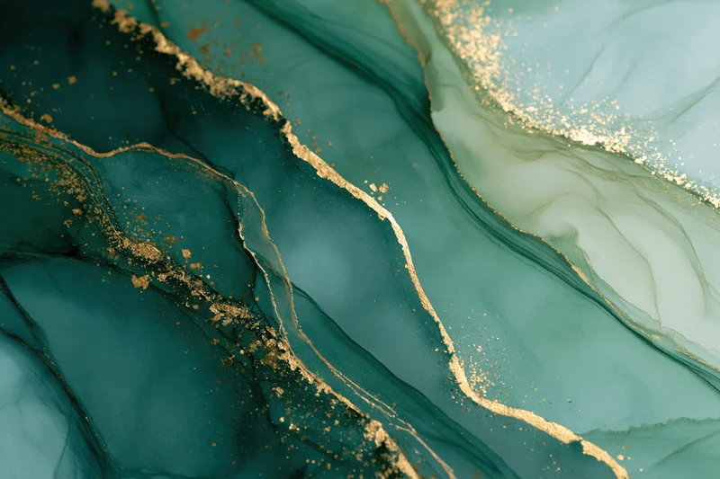Abstract fluid art with teal and gold ink swirls on paper surface
