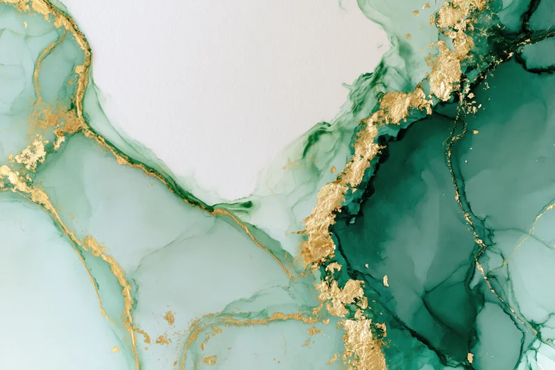 Abstract alcohol ink painting with green and gold swirls on white paper