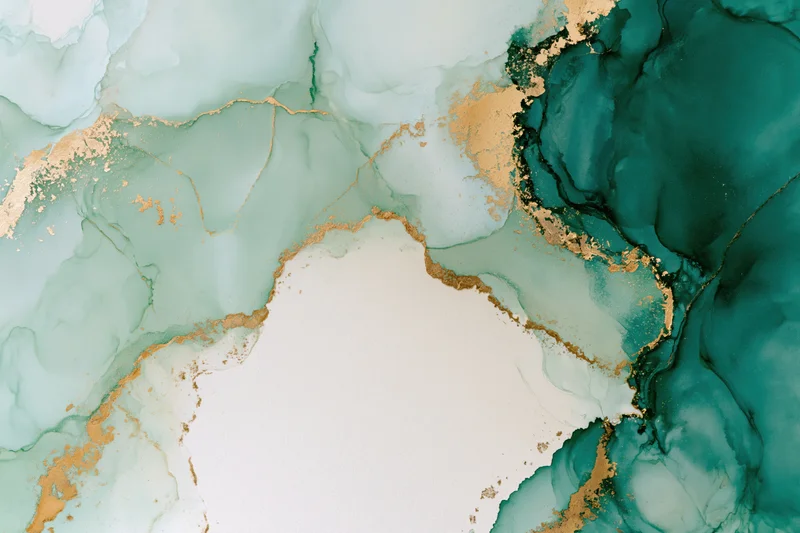 Abstract alcohol ink painting with teal, green, and gold swirls on white paper, flat lay close-up