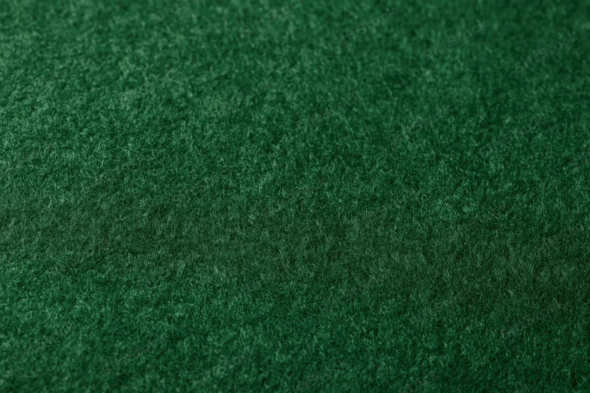 Close-up of dark green felt fabric surface filling the frame