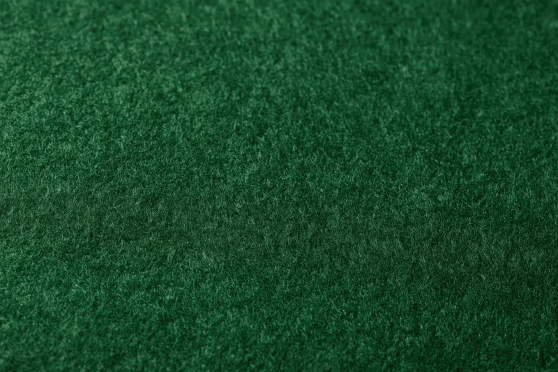 Close-up of dark green felt fabric surface filling the frame