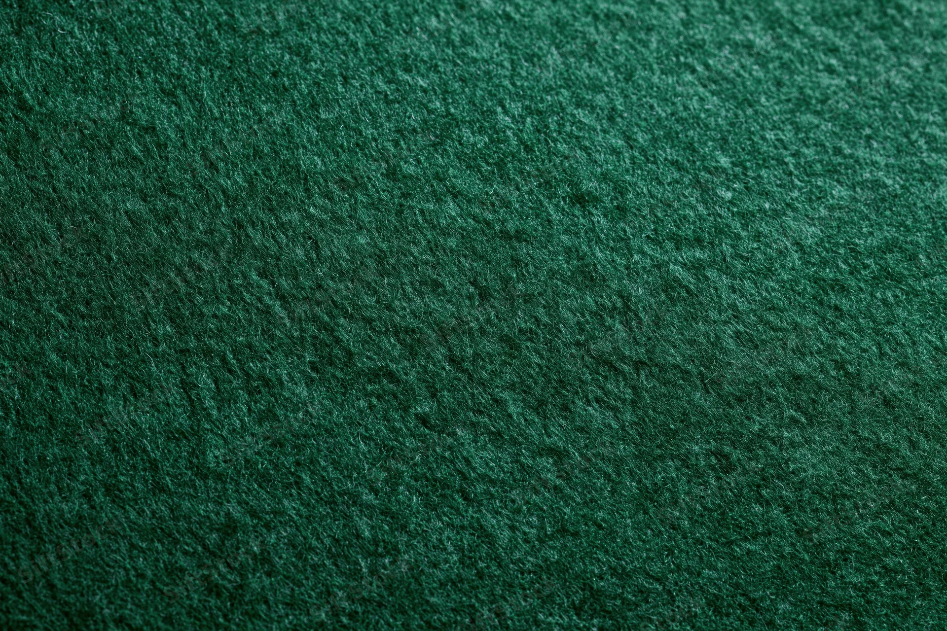 Close-up of dark green felt fabric surface filling the frame