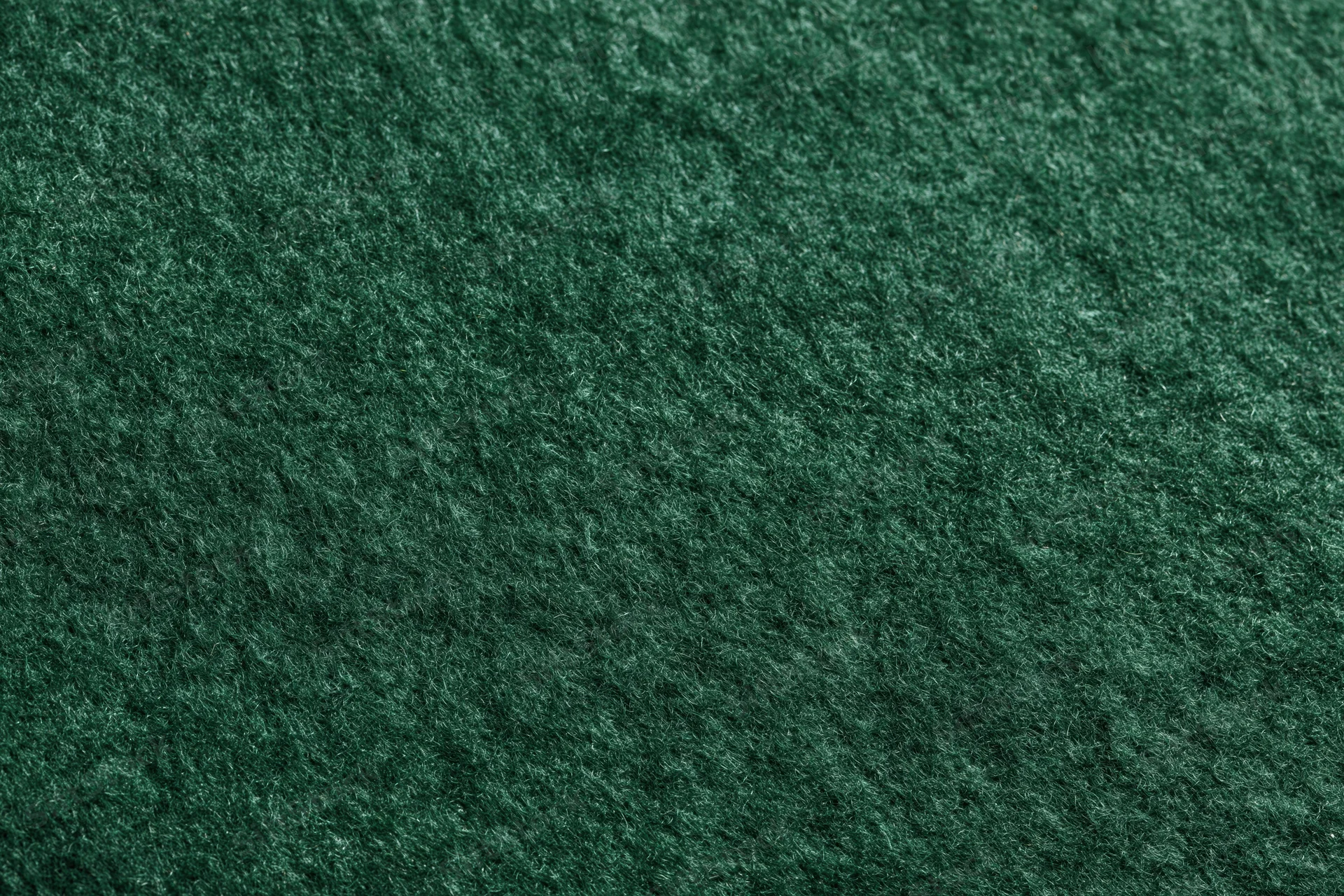 Close-up of dark green felt fabric surface filling the frame