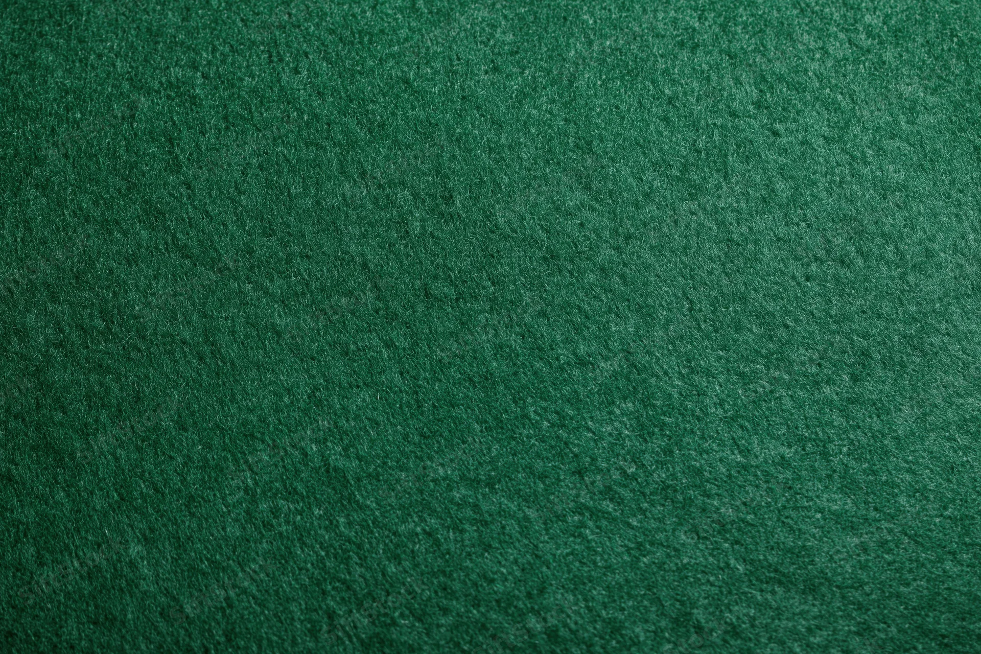 Close-up of dark green felt fabric surface filling the frame