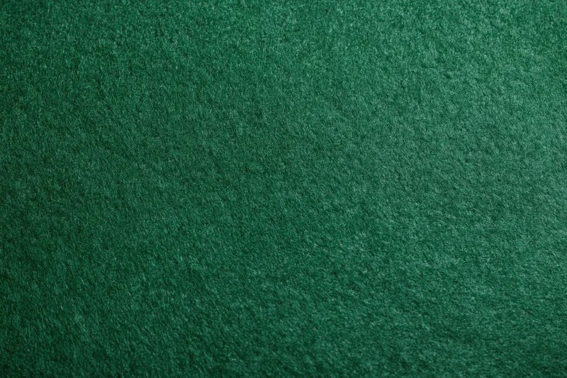 Close-up of dark green felt fabric surface filling the frame