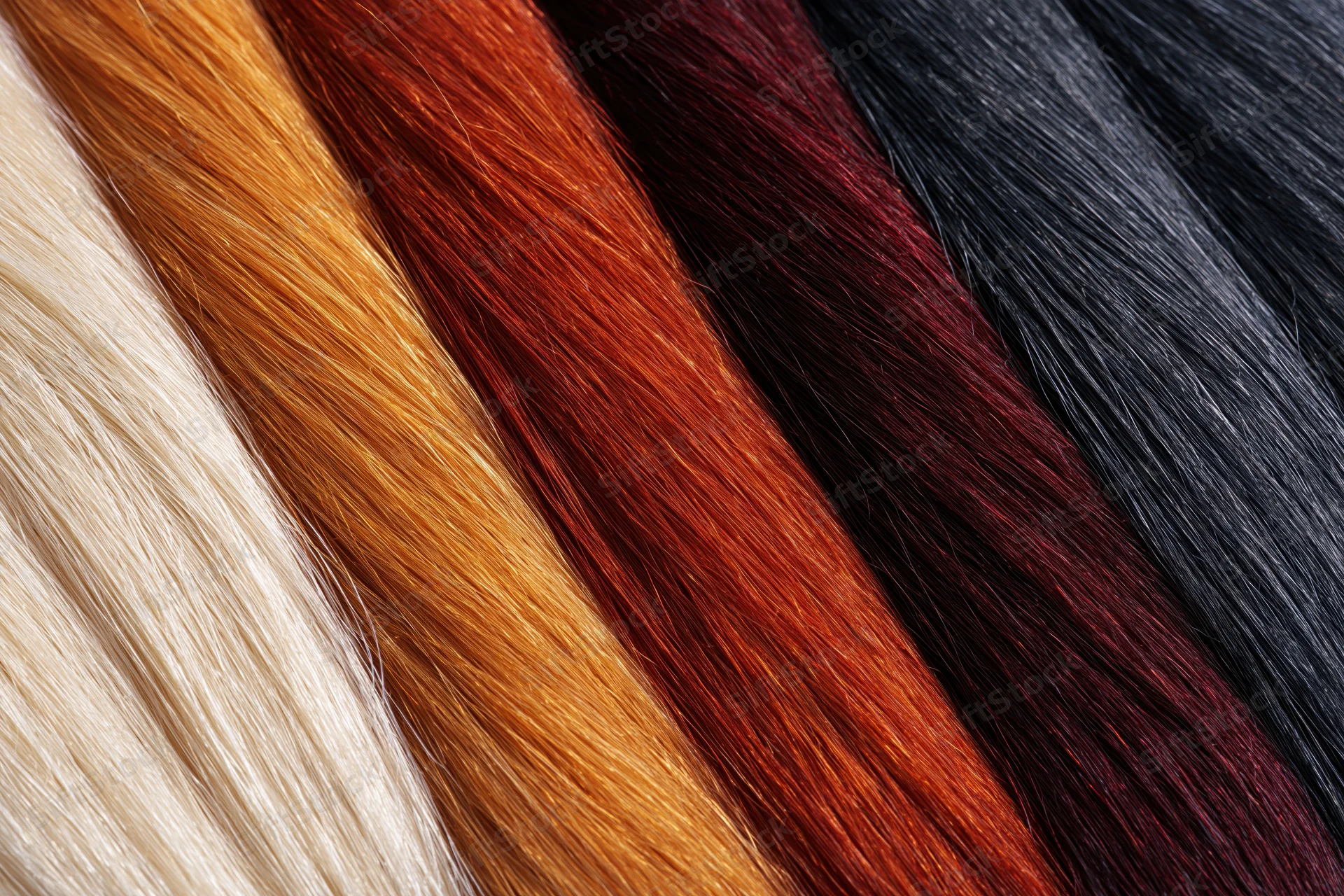 Close-up of five horizontal bands of hair color swatches arranged side by side