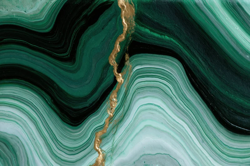 Fluid acrylic pour painting with green black and gold swirls on canvas