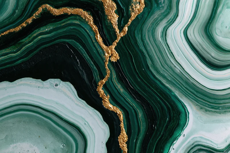 Fluid acrylic pour painting with green, gold, and black swirls on canvas