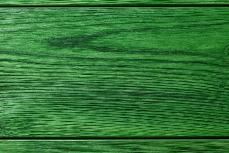 Close-up of green-painted wooden surface with horizontal planks and visible grain
