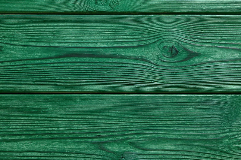 Close-up of green-painted wooden planks arranged horizontally as a textured surface
