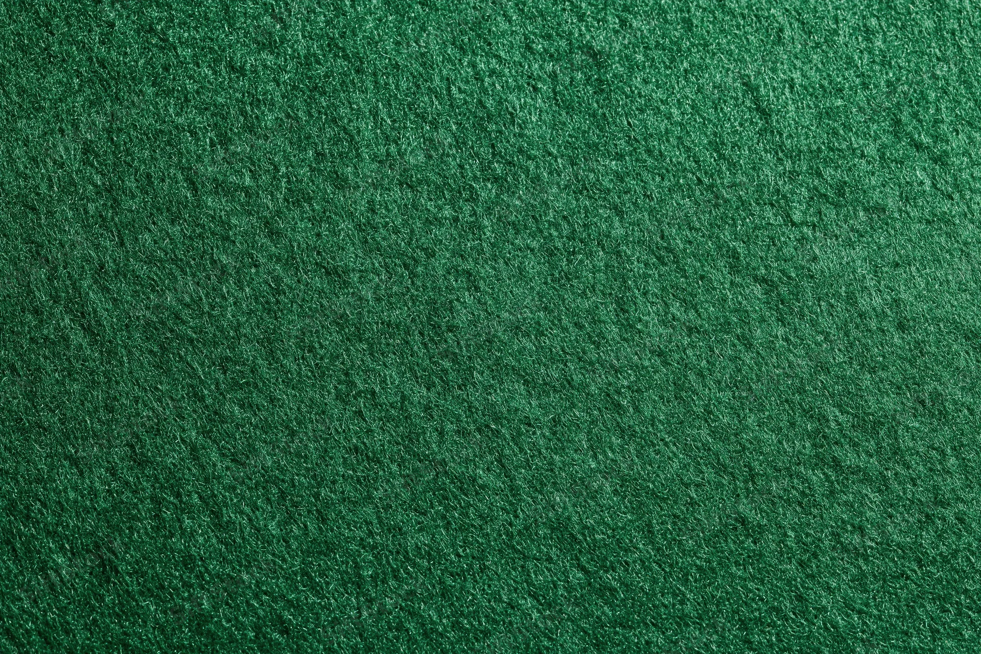 Close-up of green felt fabric surface filling the frame
