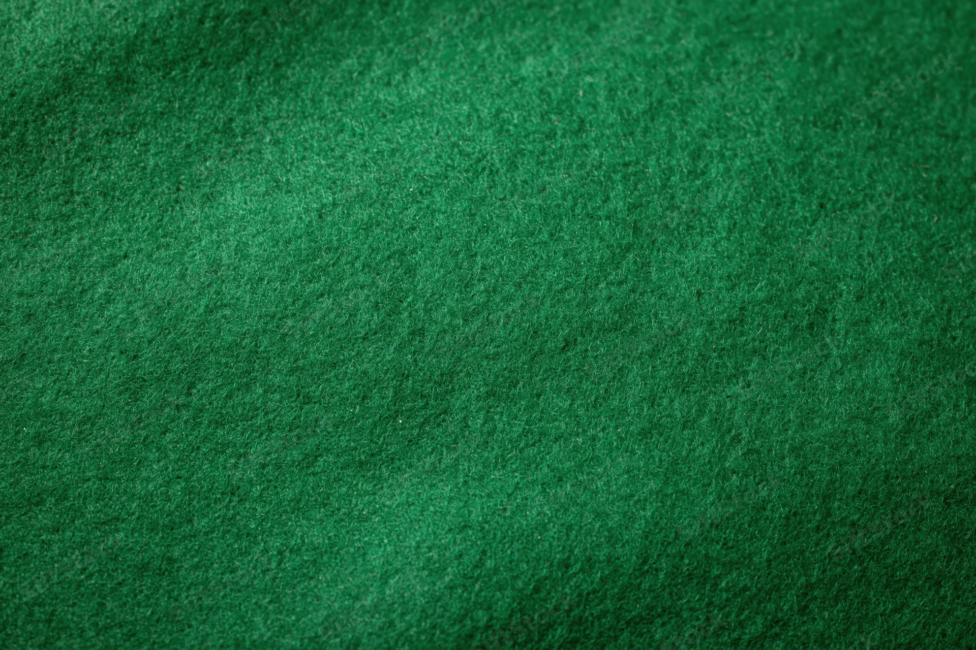 Close-up of green felt fabric surface filling the frame