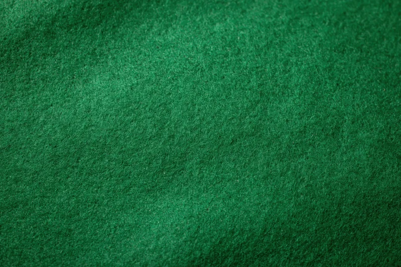Close-up of green felt fabric surface filling the frame