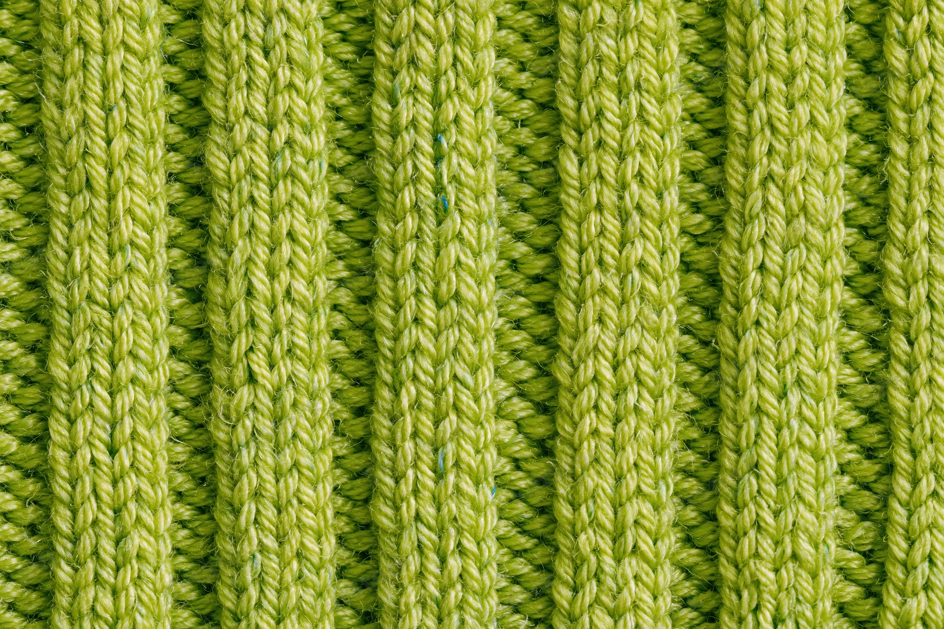 Close-up of lime green ribbed knit fabric texture filling the frame