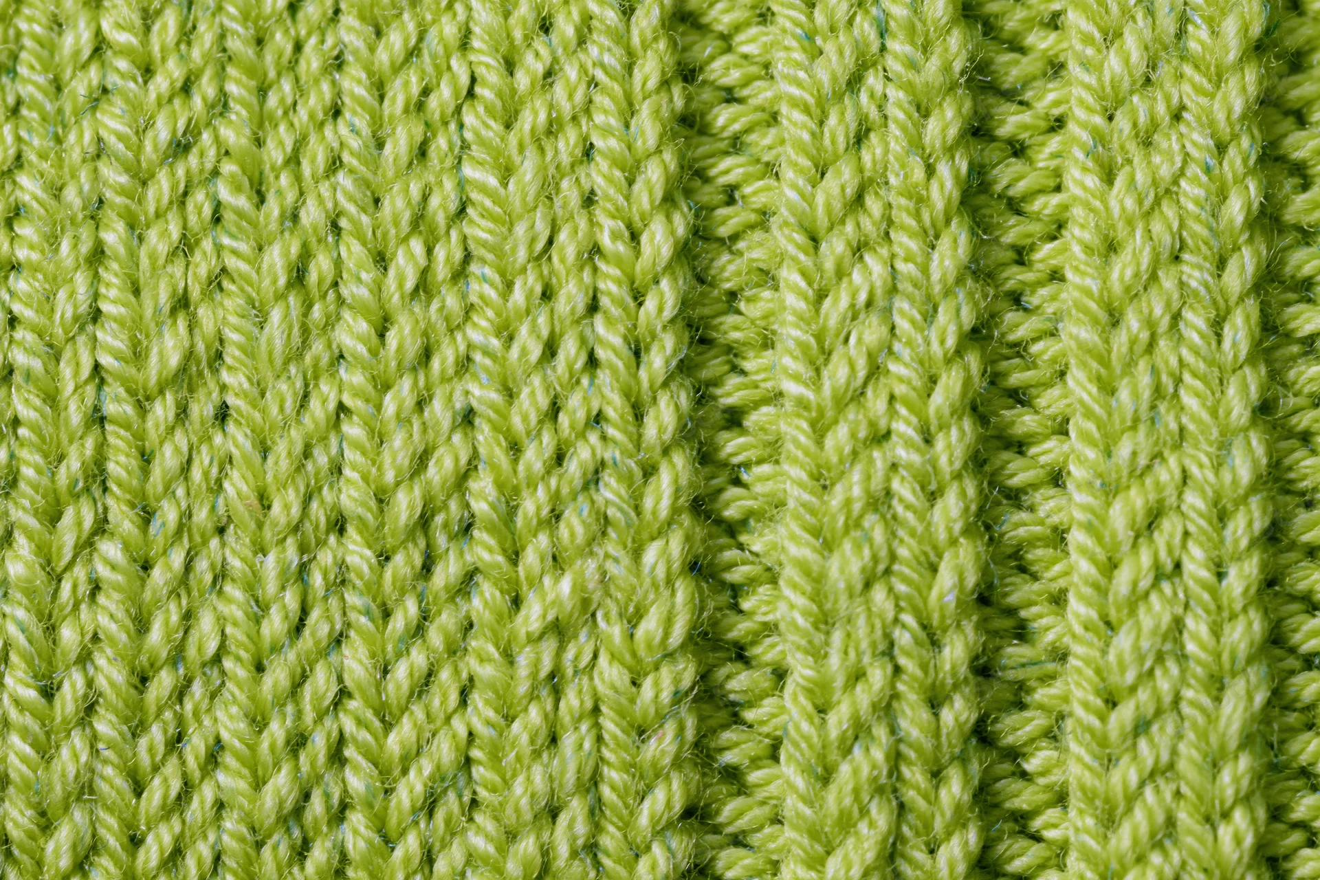 Close-up of lime green ribbed knit fabric texture filling the frame