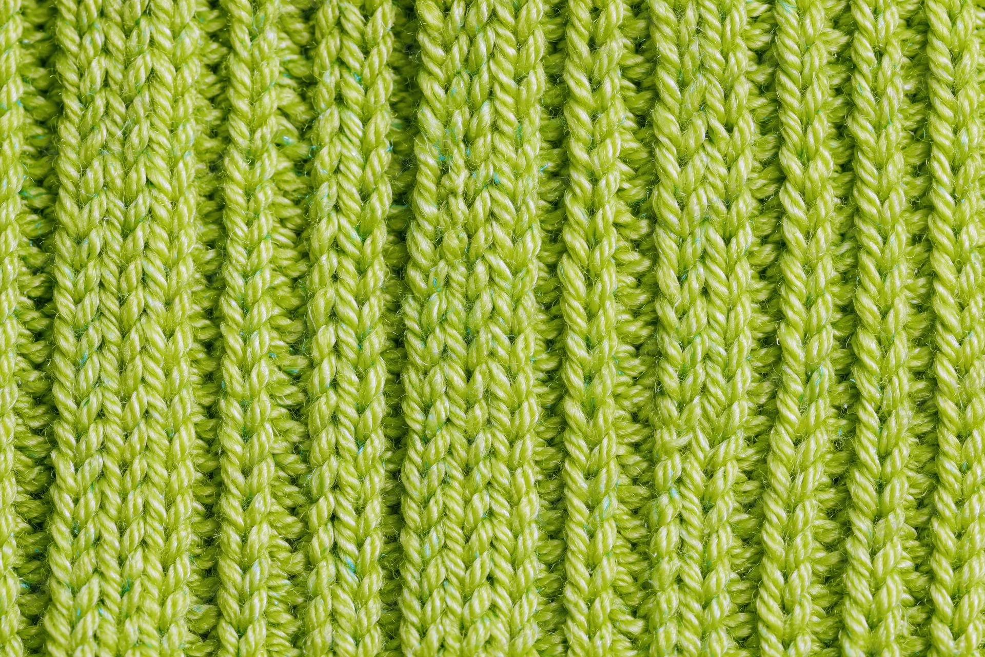 Close-up of lime green ribbed knit fabric texture filling the frame