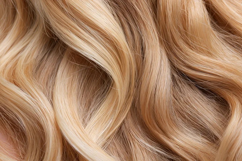 Close-up of loose wavy blonde hair filling the frame