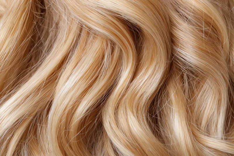 Close-up of loose wavy blonde hair filling the frame