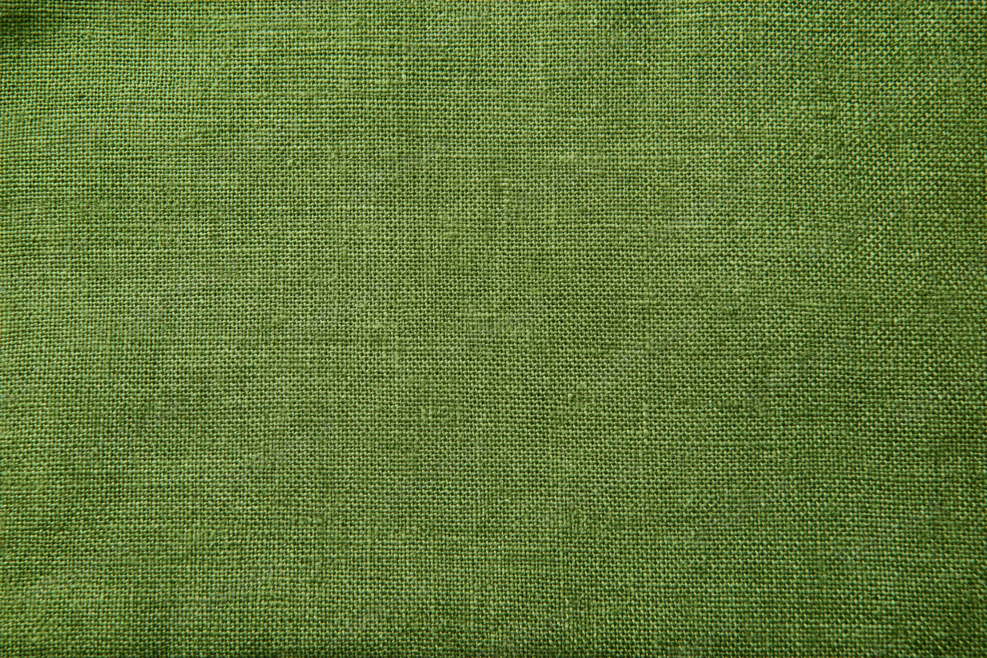 Close-up of olive green linen fabric with visible weave texture filling the frame