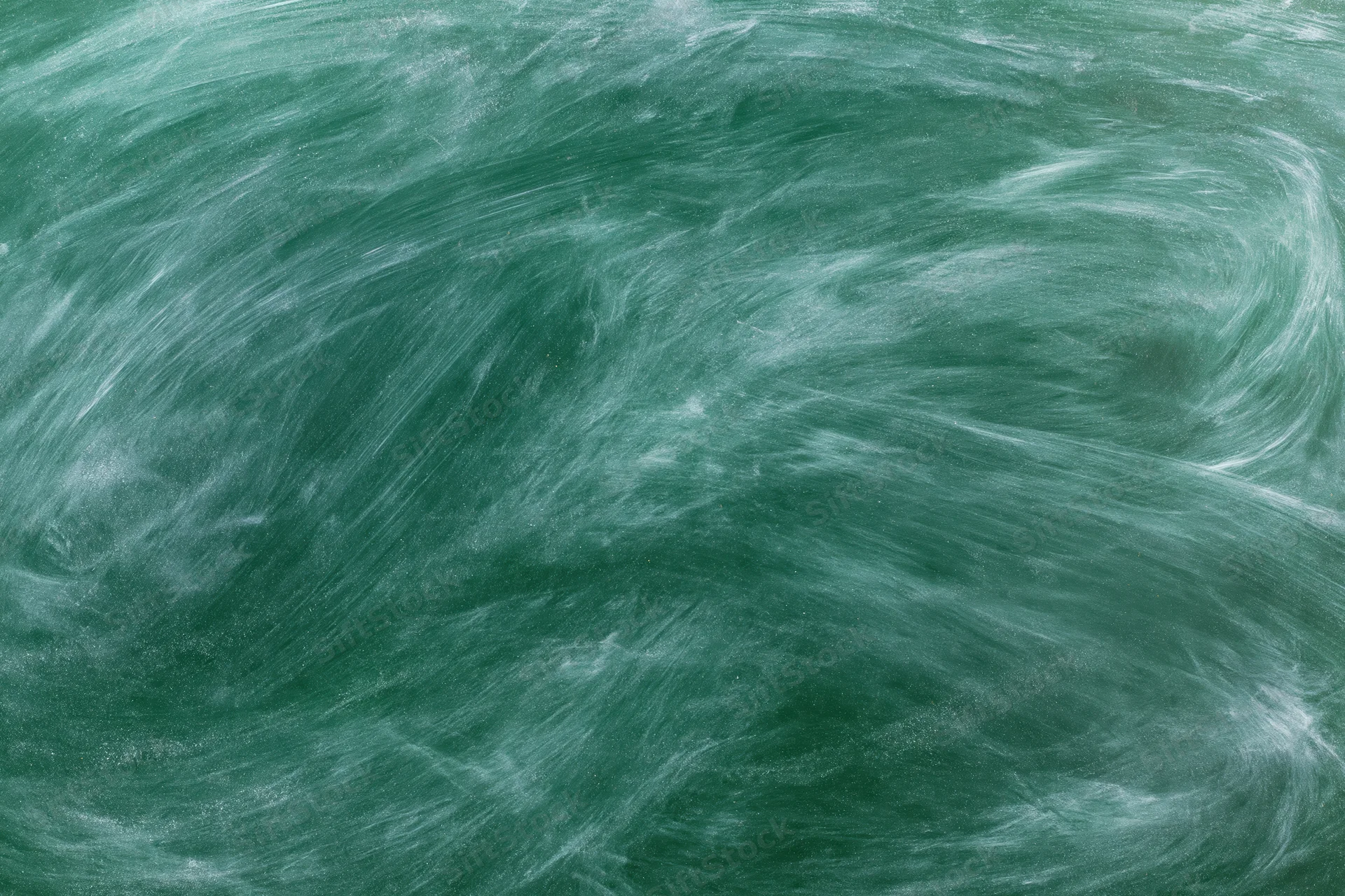 Close-up of a green chalkboard surface with smudged white chalk residue from recent erasing