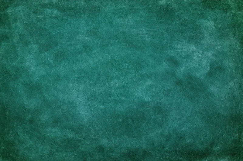 Close-up of a worn green chalkboard surface with smudged marks and residue
