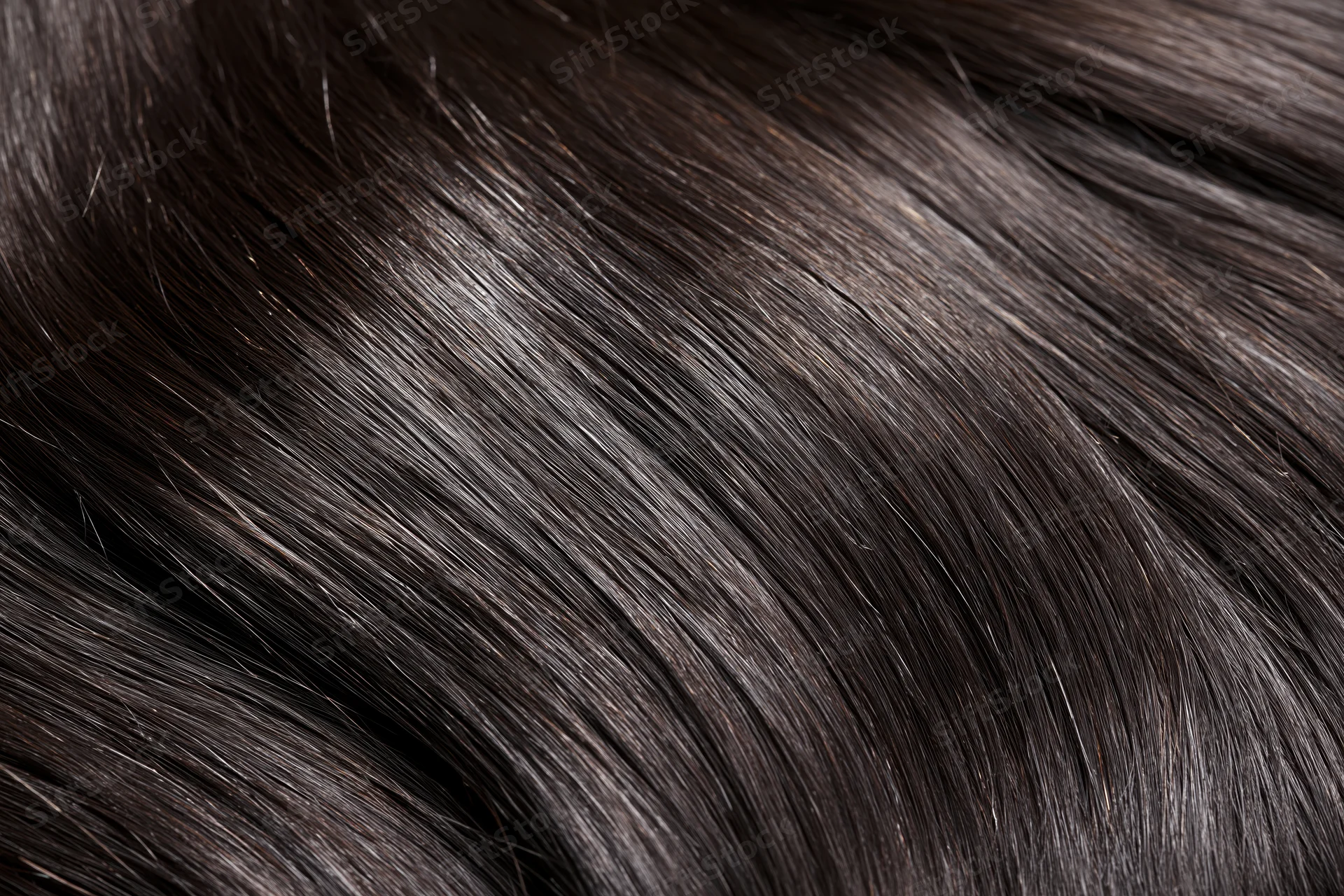 Close-up of straight dark brown-black hair strands showing smooth texture and shine
