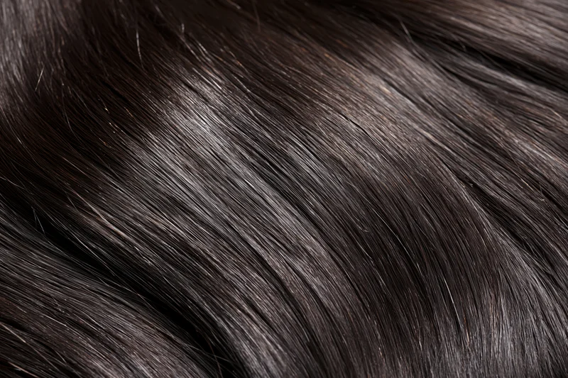 Close-up of straight dark brown-black hair strands showing smooth texture and shine