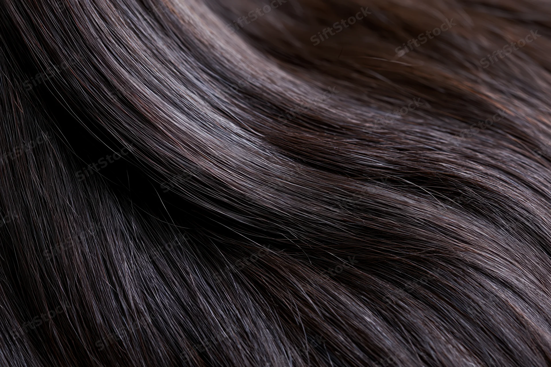 Close-up of straight dark brown-black hair strands showing smooth texture and glossy shine