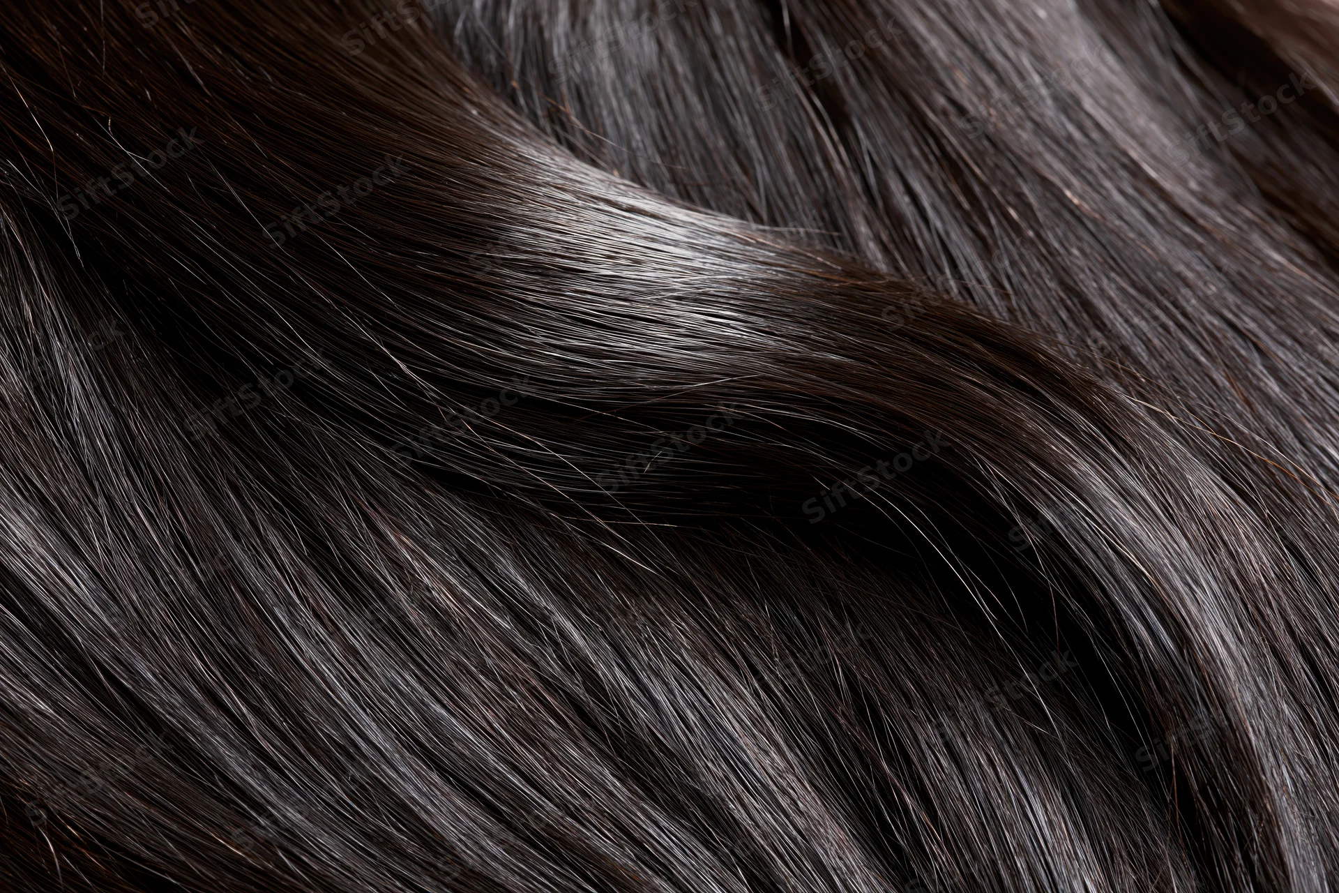 Close-up of straight dark brown-black hair strands showing smooth texture and glossy shine