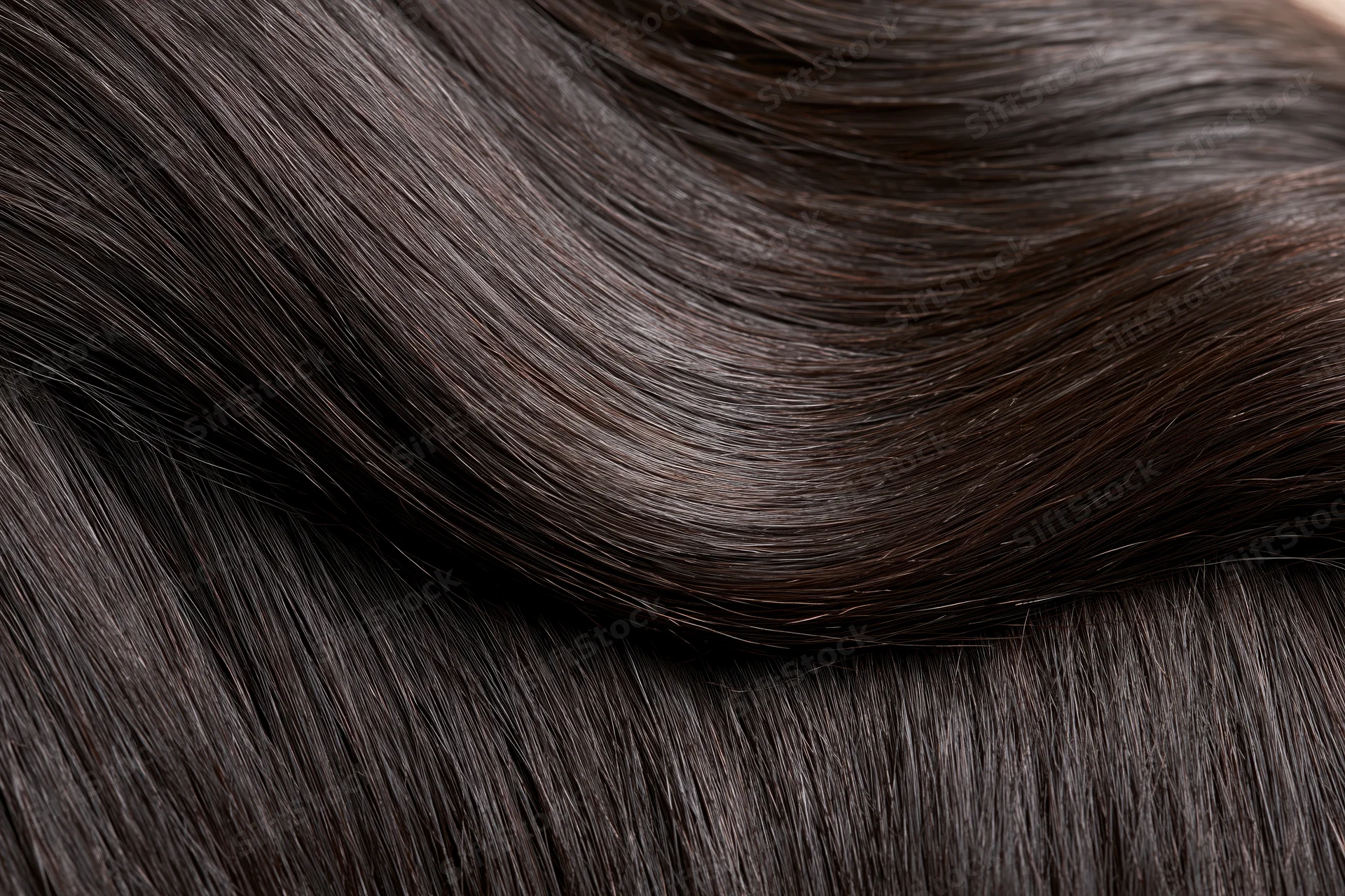 Close-up of straight dark brown-black hair strands showing smooth glossy texture