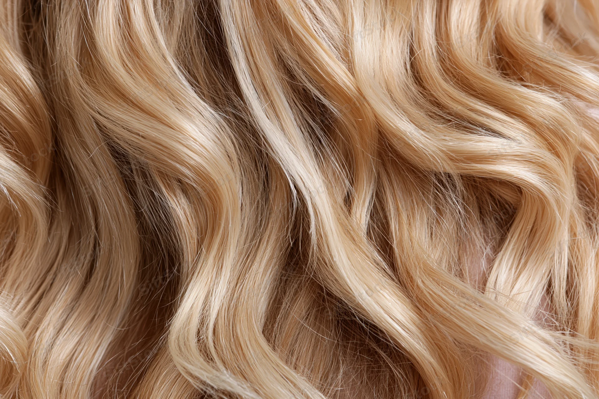 Close-up of wavy blonde hair filling the frame