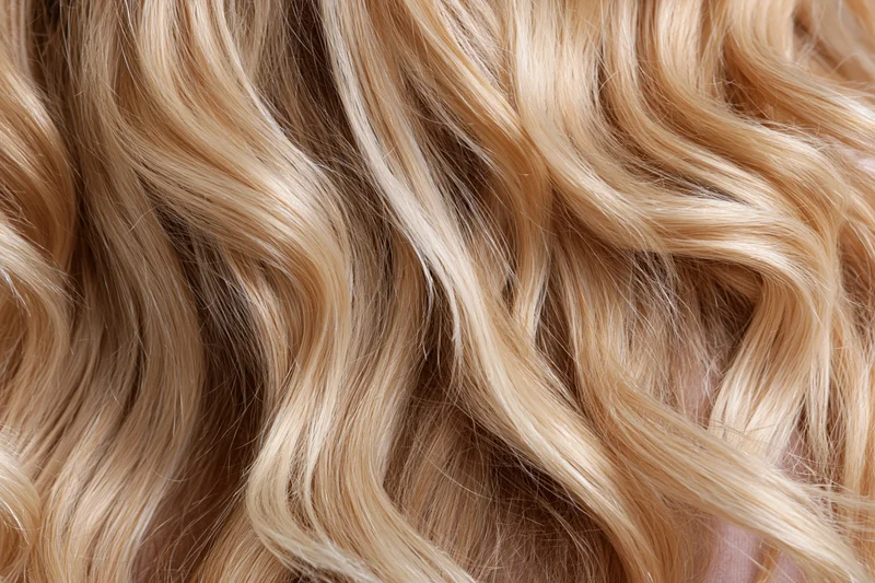 Close-up of wavy blonde hair filling the frame