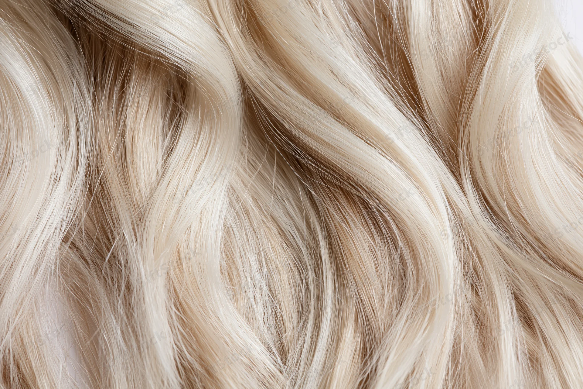 Close-up of wavy blonde hair strands with natural texture and shine